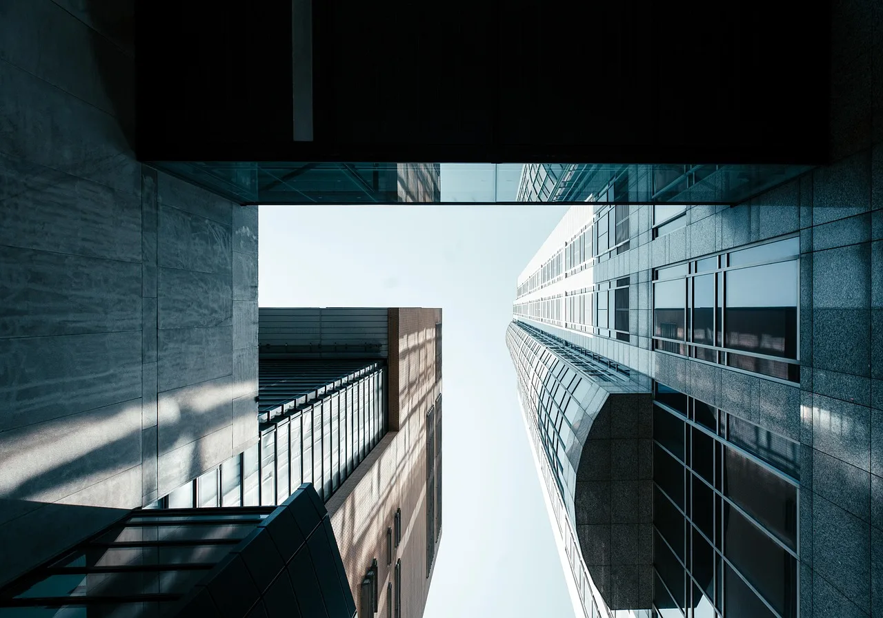 building, skyscraper, facade, modern, office building, urban, architecture, city, windows, perspective, structure, horizon, glass, reflection, business, corporate. Contracts and Salaries: The Parts Behind a Deal Total